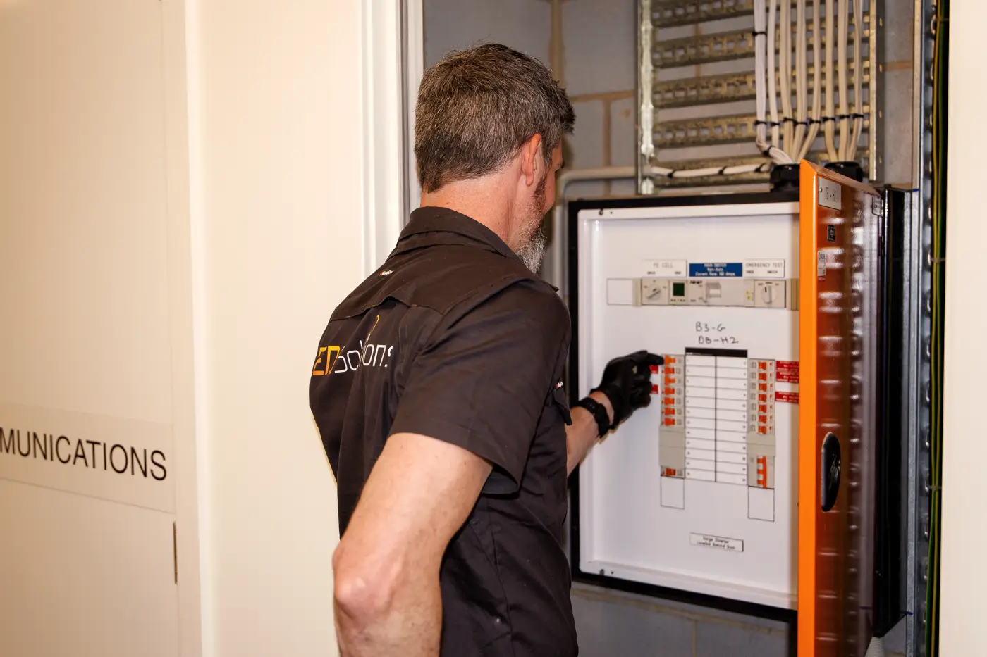 Licensed electrician working on a switchboard in Canberra